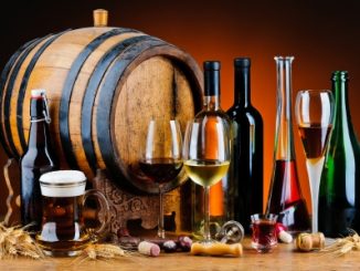 Still life with different alcoholic drinks and wooden barrel.. Sulphur dioxide in beer, wine and spirits must be monitored.