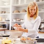 woman baking at home following recipe on a tablet
