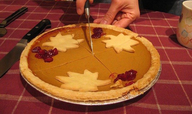Pumpkin pie being cut open