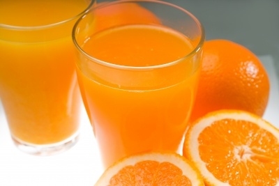 Orange juice in a glass, orange halves and segments. Membrane distillation has been used here for processing.