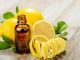 Lemon essential oil and lemon fruit on the wooden board. A place for lemon oils.