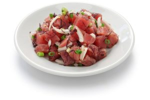 Hawaiian raw tuna salad, ahi poke with green toppings.