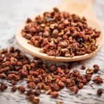 Sichuan pepper on rustic wooden board