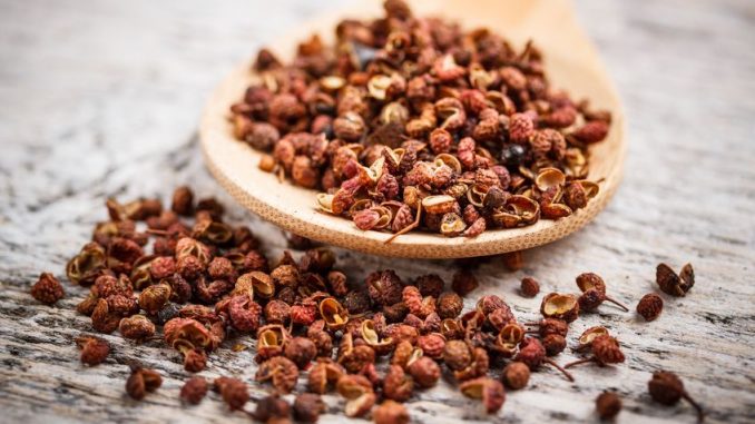 Sichuan pepper on rustic wooden board