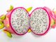 Dragonfruit cut in half to show the white pulp with black seeds.