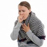 A woman who has a cough. essential oils for cough are widely considered.