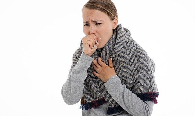 A woman who has a cough. essential oils for cough are widely considered.