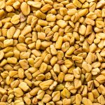 Fenugreek seeds background, spice, culinary ingredient