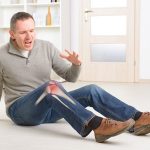 Man with painful knee joint skeleton visible with red area marked