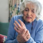 Senior Woman At Home Suffering With Arthritis