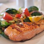 salmon on a plate. Fish consumption may prove highly beneficial for health.