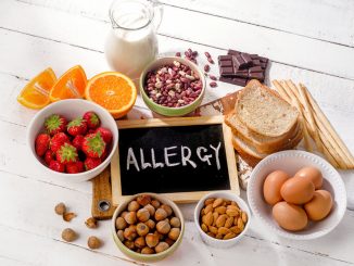Food allergies. Allergic food on wooden background.