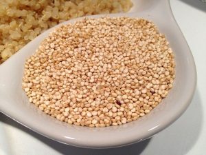 quinoa in a white ceramic ladle