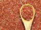 Red yeast rice, some in a wooden spoon, full picture.