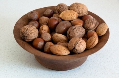 A wooden bowl of nuts. A source of Vitamin E.