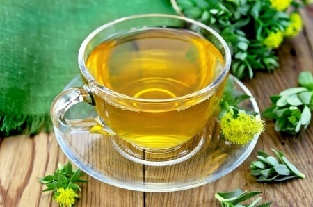 A cup of Golden Rod (Rhodiola) tea in a clear glass tea cup.