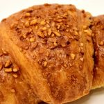A chocolate croissant on a white background.
