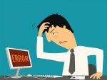 A cartoon showing a man holding his head and looking at a computer screen saying ERROR.