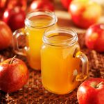 Cider apples used to make a hot cider beverage, stored in mason jars.