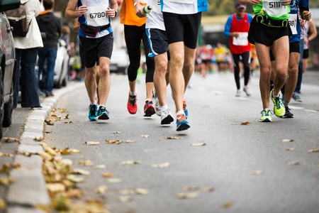marathon running race, people feet on autumn road