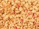 Cereals with red fruit pieces in full picture mode.
