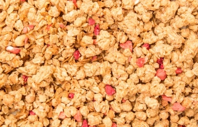 Cereals with red fruit pieces in full picture mode.