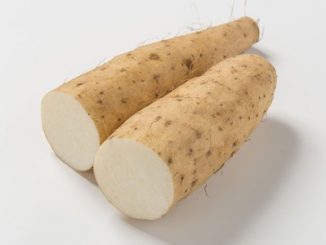 Two cut yams on a white background.