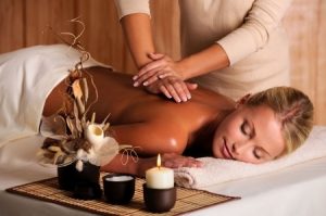 Professional masseur doing massage of female back in the beauty salon. Copyright: domenicogelermo / 123RF Stock Photo