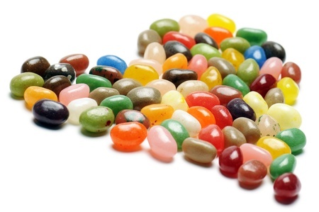 12633116 - fruit jelly beans, heart-shaped on white background