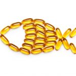 Cod liver oil capsules. Fish from the Omega 3 capsules isolated on white background. Top view, copy space, high resolution product. Health care concept