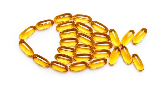 Cod liver oil capsules. Fish from the Omega 3 capsules isolated on white background. Top view, copy space, high resolution product. Health care concept