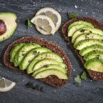 Avocado sandwich on dark rye bread made with fresh sliced avocados from above