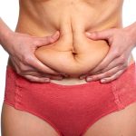 Woman fat belly. overweight and weight loss concept.. Fight the flab with meal replacement shakes.