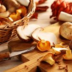 45809536 - preparing assorted fresh oyster or pleurotus mushrooms in the kitchen slicing them on a chopping board for healthy vegetarian autumn cuisine