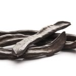 Carob pods on a white background.