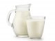 Natural whole milk in a jug and a glass isolated on a white background closeup. A source of milk protein isolate too.