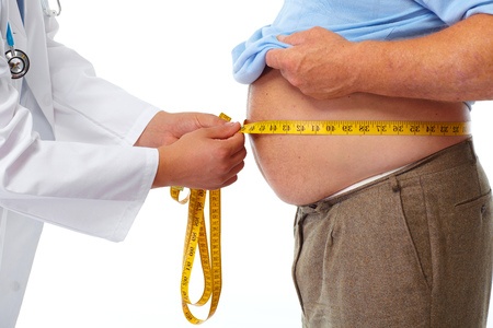Doctor measuring obese man waist body fat. obesity and weight loss. May be he needs to be on the 5:2 Diet.