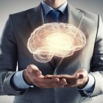 Close up of businessman holding digital image of brain in palms. Choline is an important factor in reducing risk of dementia.