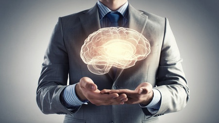 Close up of businessman holding digital image of brain in palms. Choline is an important factor in reducing risk of dementia.