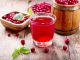 47600813 - glass of cranberry juice with fresh berries on wooden table