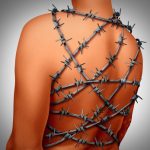 Chronic back pain and human spinal backache with a body showing the vertebra area wrapped in barbed or barb wire as a medical health care concept for arthritis or joint stress and painful suffering due to disk or joint inflammation.