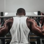 43776533 - weight training african doing bodybuilding in gym. Protein supplementation.
