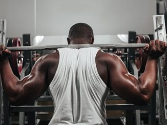 43776533 - weight training african doing bodybuilding in gym. Protein supplementation.