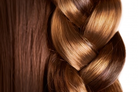 Braid hairstyle - brown long hair close up -healthy hair.