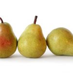 Three juicy ripe golden pears on white background. Healthy food.