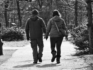 A couple walking hand in hand down a country path. Betaine may help them in this health.