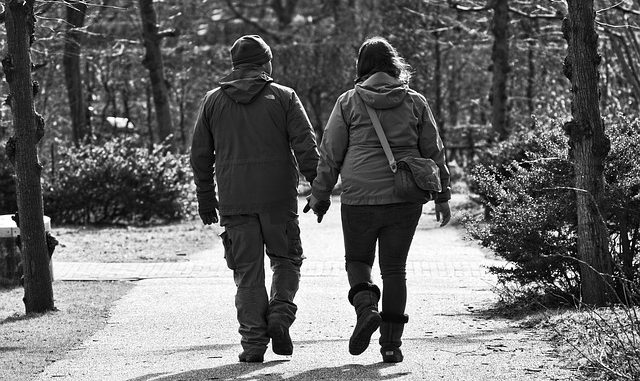 A couple walking hand in hand down a country path. Betaine may help them in this health.
