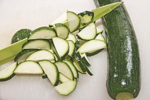 Courgette sliced by a knife