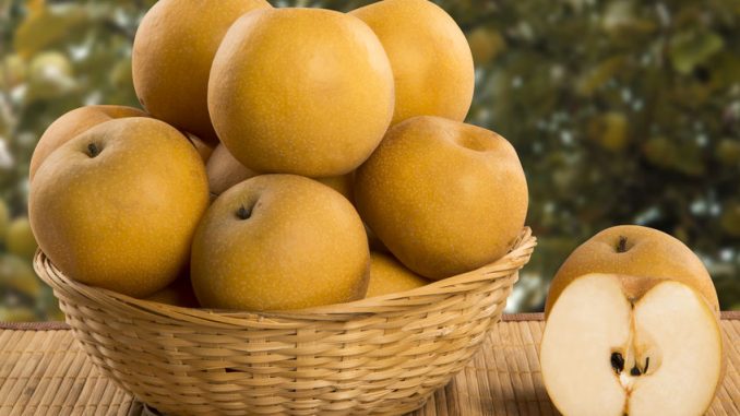 Some asian pears over a wooden surface. Fresh fruits
