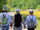 Three friends from the back walking down a lane. have all three experienced the menopause yet ?